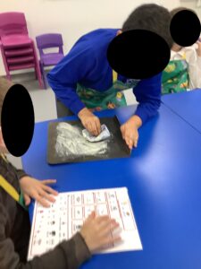 Adding flour to a tray for rolling